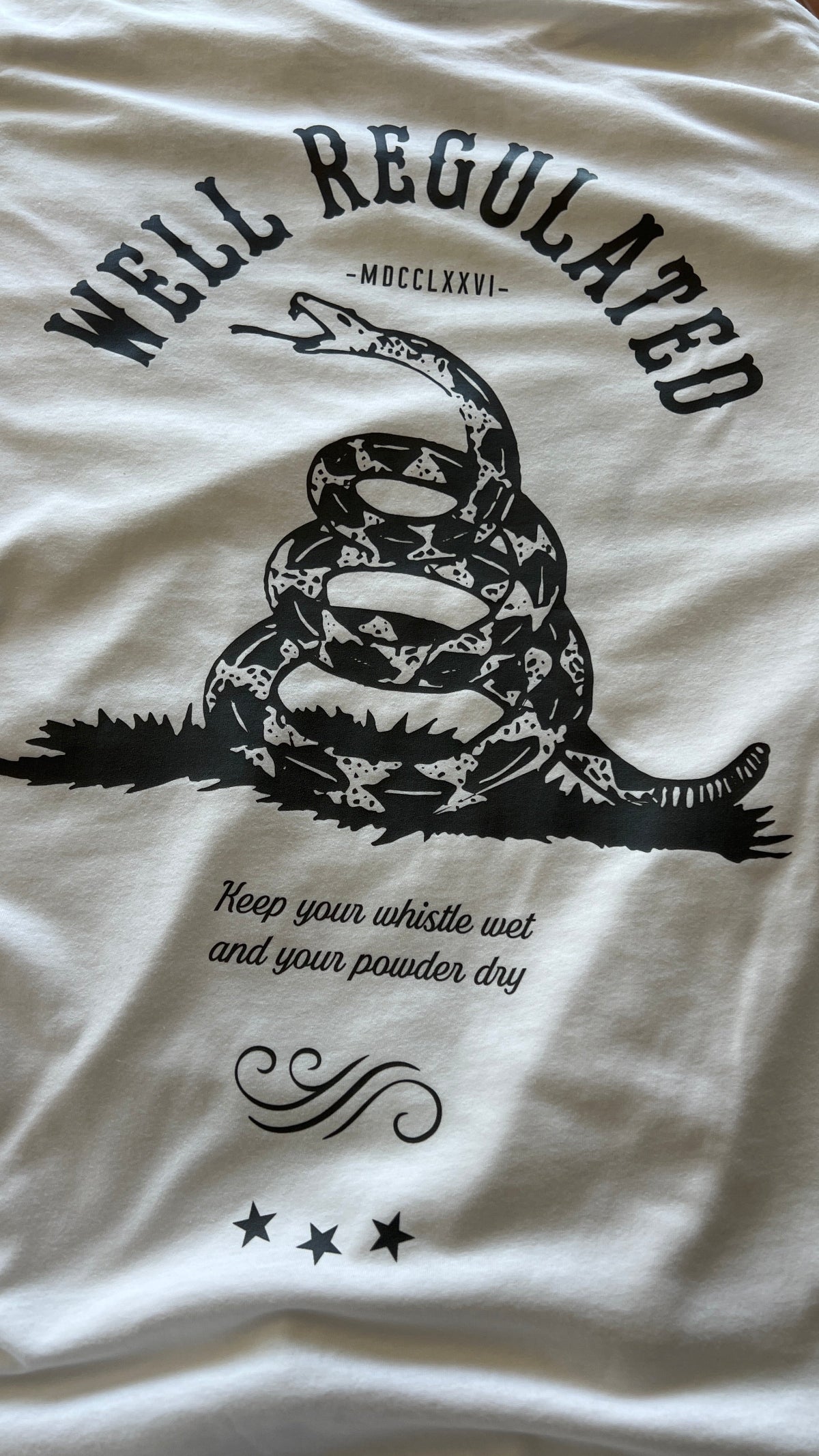 White Carbine Cowboys Well Regulated tee back. Keep your whistle wet and your powder dry.